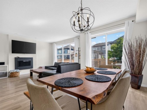 228 Masters Crescent Se, Calgary, AB - Indoor Photo Showing Dining Room With Fireplace