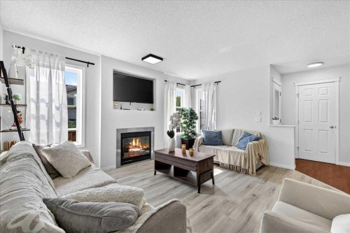333 Bridleridge View Sw, Calgary, AB - Indoor Photo Showing Living Room With Fireplace