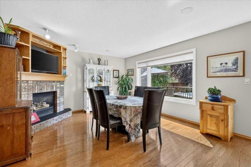 23 Cranfield Crescent Se, Calgary, AB - Indoor Photo Showing Dining Room With Fireplace