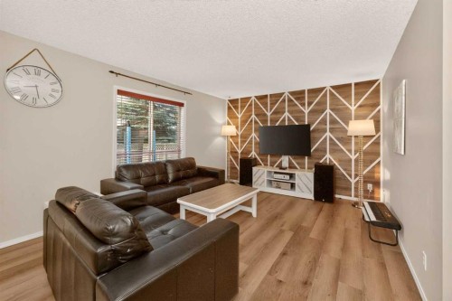 137 Douglas Glen Manor Se, Calgary, AB - Indoor Photo Showing Living Room With Fireplace