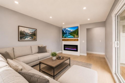 755 Penbrooke Road Se, Calgary, AB - Indoor Photo Showing Living Room With Fireplace