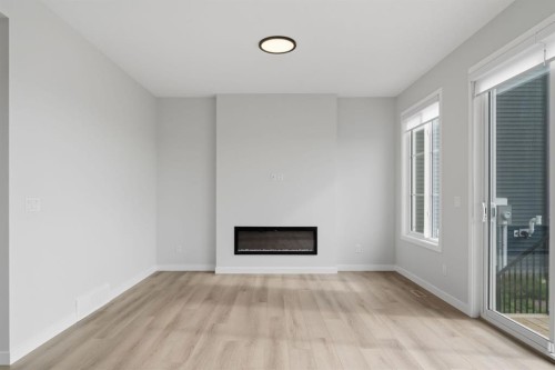 212 Lewiston Landing Ne, Calgary, AB - Indoor Photo Showing Other Room With Fireplace
