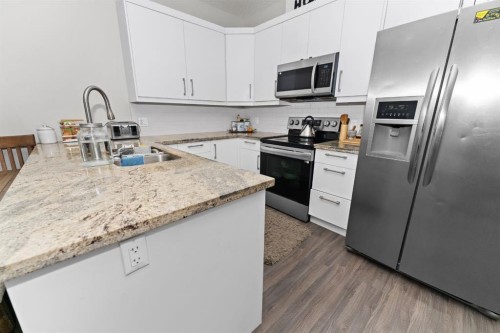 114-300 Marina Drive, Chestermere, AB - Indoor Photo Showing Kitchen With Stainless Steel Kitchen With Double Sink With Upgraded Kitchen