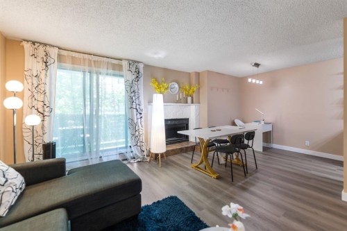 4-1607 26 Avenue Sw, Calgary, AB - Indoor Photo Showing Other Room With Fireplace