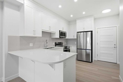1410-81 Arbour Lake View Nw, Calgary, AB - Indoor Photo Showing Kitchen With Stainless Steel Kitchen With Double Sink With Upgraded Kitchen