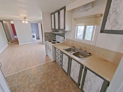 4809 52 Street, Stavely, AB - Indoor Photo Showing Kitchen With Double Sink