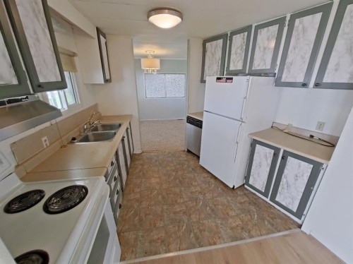 4809 52 Street, Stavely, AB - Indoor Photo Showing Kitchen With Double Sink