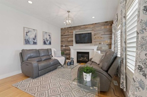 1826 Baywater Street Sw, Airdrie, AB - Indoor Photo Showing Living Room With Fireplace