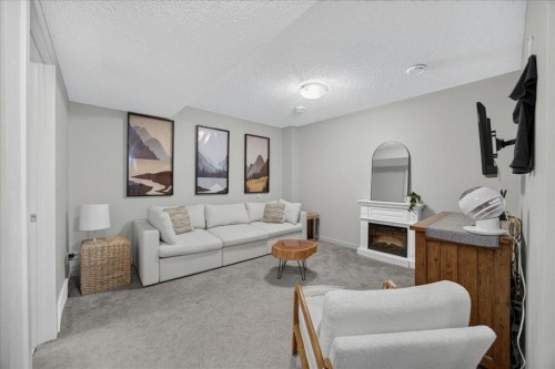 146 Sunset Road, Cochrane, AB - Indoor Photo Showing Living Room With Fireplace