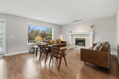 307 Hidden Cove Nw, Calgary, AB - Indoor Photo Showing Living Room With Fireplace