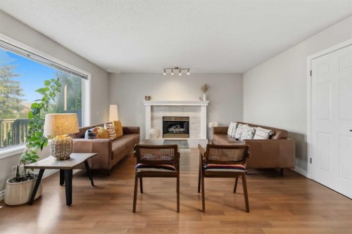 307 Hidden Cove Nw, Calgary, AB - Indoor Photo Showing Living Room With Fireplace