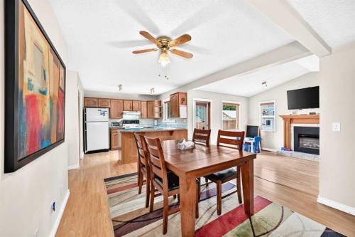 216 Millbank Road Sw, Calgary, AB - Indoor Photo Showing Dining Room With Fireplace
