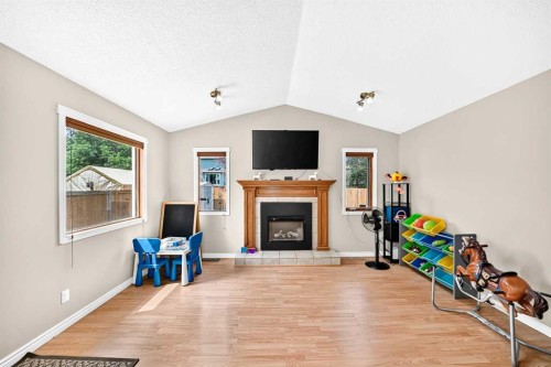 216 Millbank Road Sw, Calgary, AB - Indoor Photo Showing Other Room With Fireplace