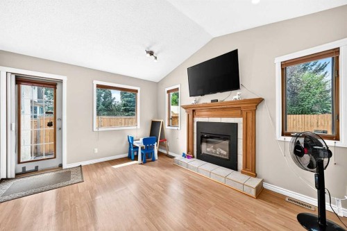 216 Millbank Road Sw, Calgary, AB - Indoor Photo Showing Living Room With Fireplace
