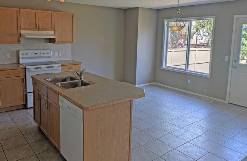 34 Coopers Close Sw, Airdrie, AB - Indoor Photo Showing Kitchen With Double Sink