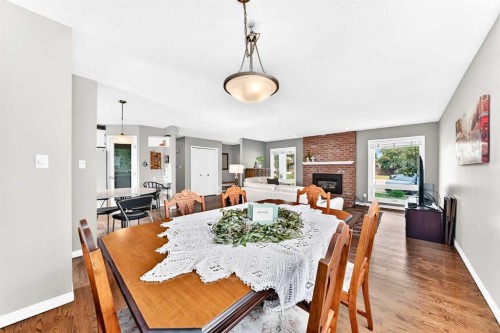 256 Midvalley Place Se, Calgary, AB - Indoor Photo Showing Dining Room With Fireplace