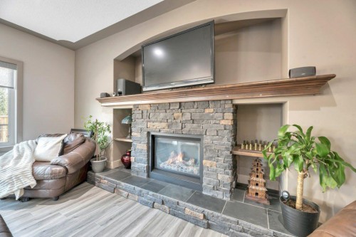 101 Hawkmere Place, Chestermere, AB - Indoor Photo Showing Living Room With Fireplace