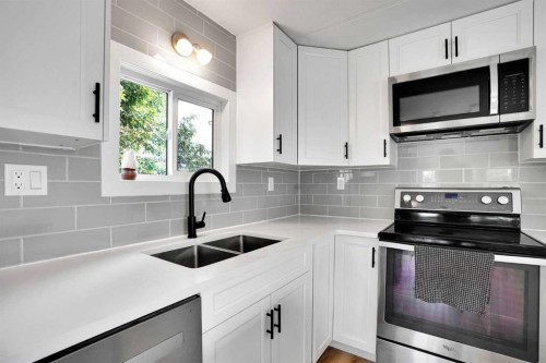 64 Huntwell Way Ne, Calgary, AB - Indoor Photo Showing Kitchen With Double Sink With Upgraded Kitchen