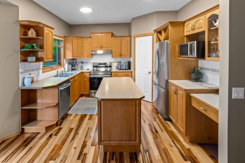 30 Gleneagles View, Cochrane, AB - Indoor Photo Showing Kitchen With Double Sink