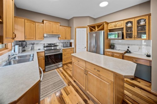 30 Gleneagles View, Cochrane, AB - Indoor Photo Showing Kitchen With Double Sink
