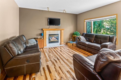 30 Gleneagles View, Cochrane, AB - Indoor Photo Showing Living Room With Fireplace