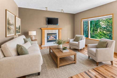 30 Gleneagles View, Cochrane, AB - Indoor Photo Showing Living Room With Fireplace