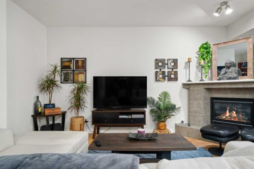 4203-24 Hemlock Crescent Sw, Calgary, AB - Indoor Photo Showing Living Room With Fireplace