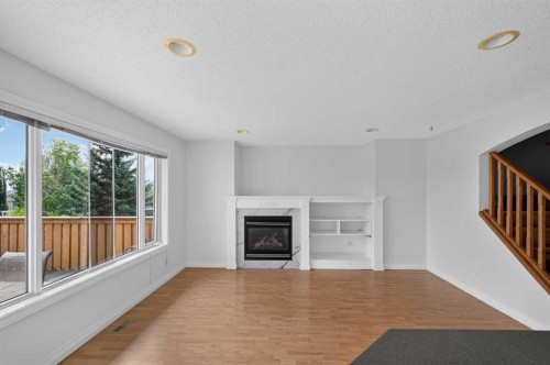 126 Bridlewood Way Sw, Calgary, AB - Indoor Photo Showing Living Room With Fireplace