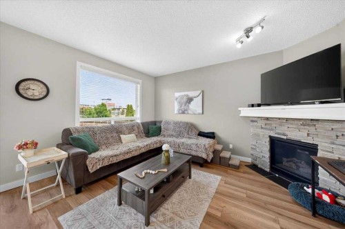 251 Hillcrest Circle Sw, Airdrie, AB - Indoor Photo Showing Living Room With Fireplace
