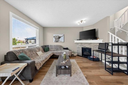 251 Hillcrest Circle Sw, Airdrie, AB - Indoor Photo Showing Living Room With Fireplace