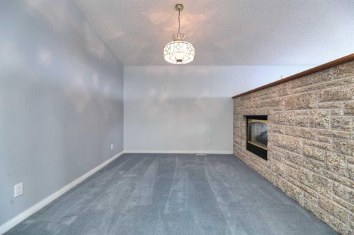 8 Prominence Path Sw, Calgary, AB - Indoor Photo Showing Other Room With Fireplace
