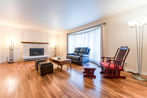 240 Canterville Drive Sw, Calgary, AB - Indoor Photo Showing Living Room With Fireplace