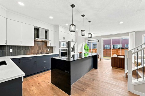 945 Chinook Winds Sw, Airdrie, AB - Indoor Photo Showing Kitchen With Double Sink With Upgraded Kitchen