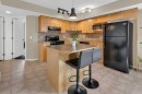 411-140 Sagewood Boulevard Sw, Airdrie, AB  - Indoor Photo Showing Kitchen With Double Sink 