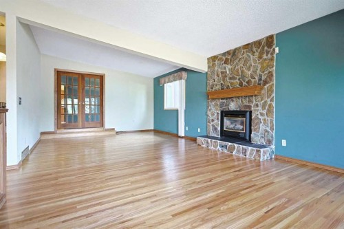 4904 Verulum Place Nw, Calgary, AB - Indoor Photo Showing Living Room With Fireplace