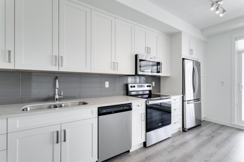 313-300 Auburn Meadows Common Se, Calgary, AB - Indoor Photo Showing Kitchen With Stainless Steel Kitchen With Double Sink