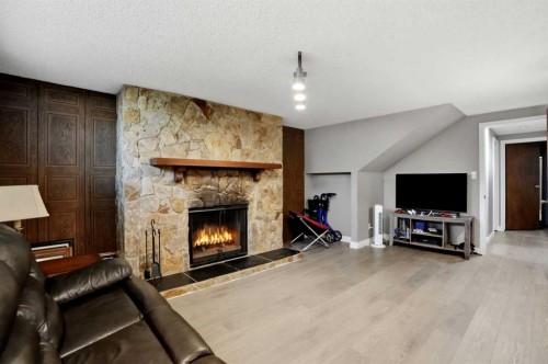 3056 32A Street Se, Calgary, AB - Indoor Photo Showing Living Room With Fireplace