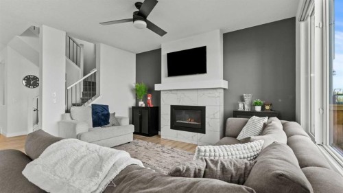 152 Threepoint Cove, Okotoks, AB - Indoor Photo Showing Living Room With Fireplace