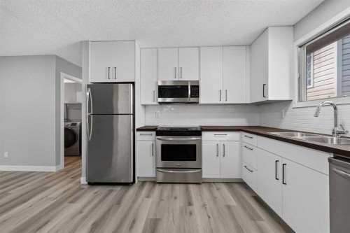 723 55 Avenue Sw, Calgary, AB - Indoor Photo Showing Kitchen With Double Sink