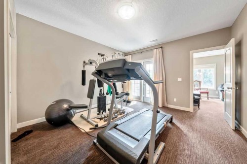 259 Willow Ridge Manor, Diamond Valley, AB - Indoor Photo Showing Gym Room