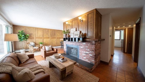 201-512 Cedar Crescent Sw, Calgary, AB - Indoor Photo Showing Other Room With Fireplace