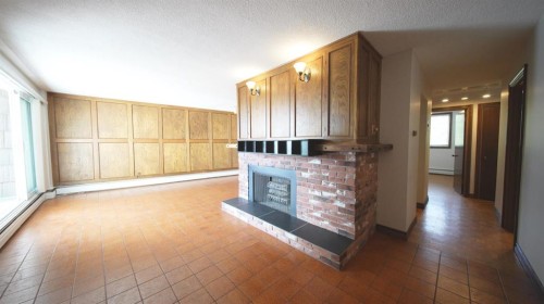 201-512 Cedar Crescent Sw, Calgary, AB - Indoor Photo Showing Other Room With Fireplace