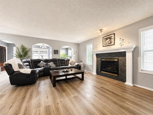 42 Inverness View Se, Calgary, AB - Indoor Photo Showing Living Room With Fireplace