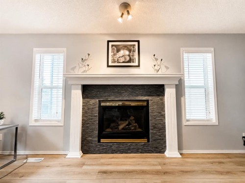 42 Inverness View Se, Calgary, AB - Indoor Photo Showing Living Room With Fireplace