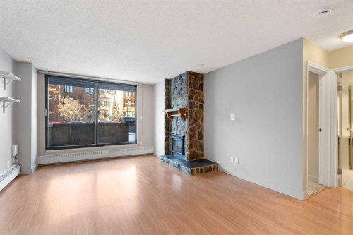105-345 4 Avenue Ne, Calgary, AB - Indoor Photo Showing Living Room With Fireplace