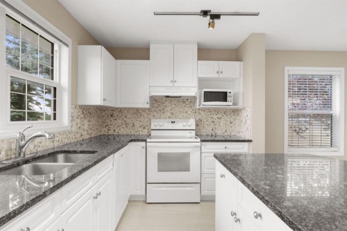 147-7707 Martha'S Haven Park Ne, Calgary, AB - Indoor Photo Showing Kitchen With Double Sink