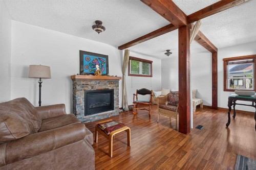 241 25 Avenue Ne, Calgary, AB - Indoor Photo Showing Living Room With Fireplace