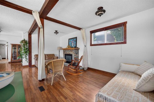 241 25 Avenue Ne, Calgary, AB - Indoor Photo Showing Living Room With Fireplace