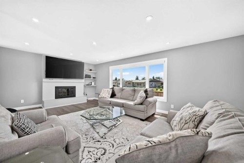 4932 Rundlehorn Drive Ne, Calgary, AB - Indoor Photo Showing Living Room With Fireplace