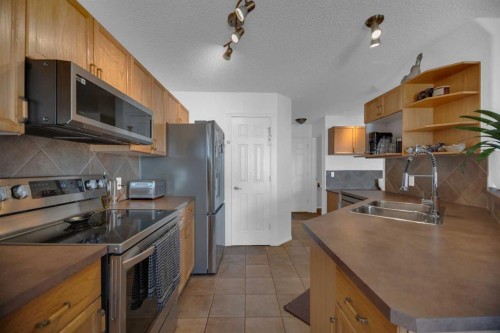 154 Bridlewood Court Sw, Calgary, AB - Indoor Photo Showing Kitchen With Stainless Steel Kitchen With Double Sink